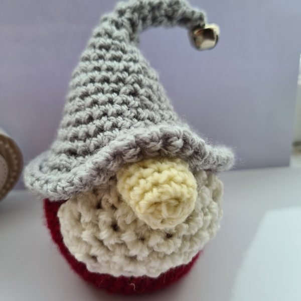 Deep red crochet gnome with bell topper